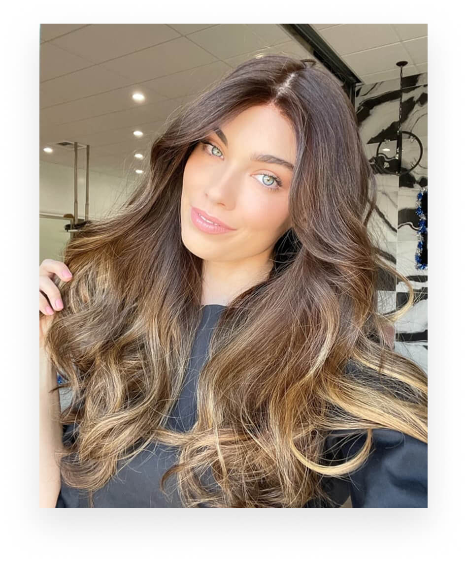 Woman wearing a styled and colored Milano human-hair topper